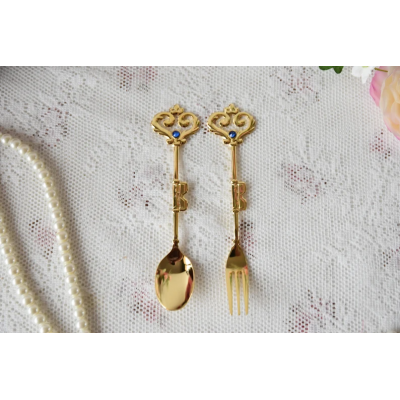 Vintage inspired spoon and fork pair in golden color with blue decoration
