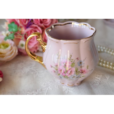 Pink porcelain mug with golden decorations