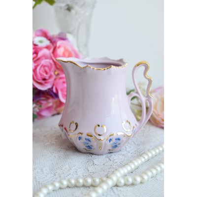 Pink porcelain milk jug with blue flowers